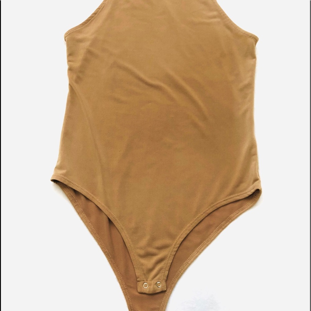 Tight fitting beige body suit w/ spaghetti straps